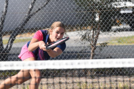 de Minaur’s Eljah Keam makes a backhand return on Saturday.