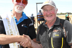 A Grade shooter Peter Mellington, left, was all smiles after claiming the overall single barrel championship. He was presented a winner’s sash by club president Roger Lehmann.