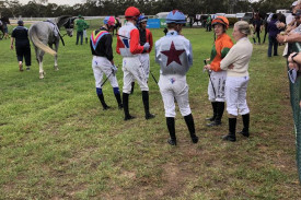 Jockeys waiting in the mounting yard for the decision on the barrier malfunction in race one.