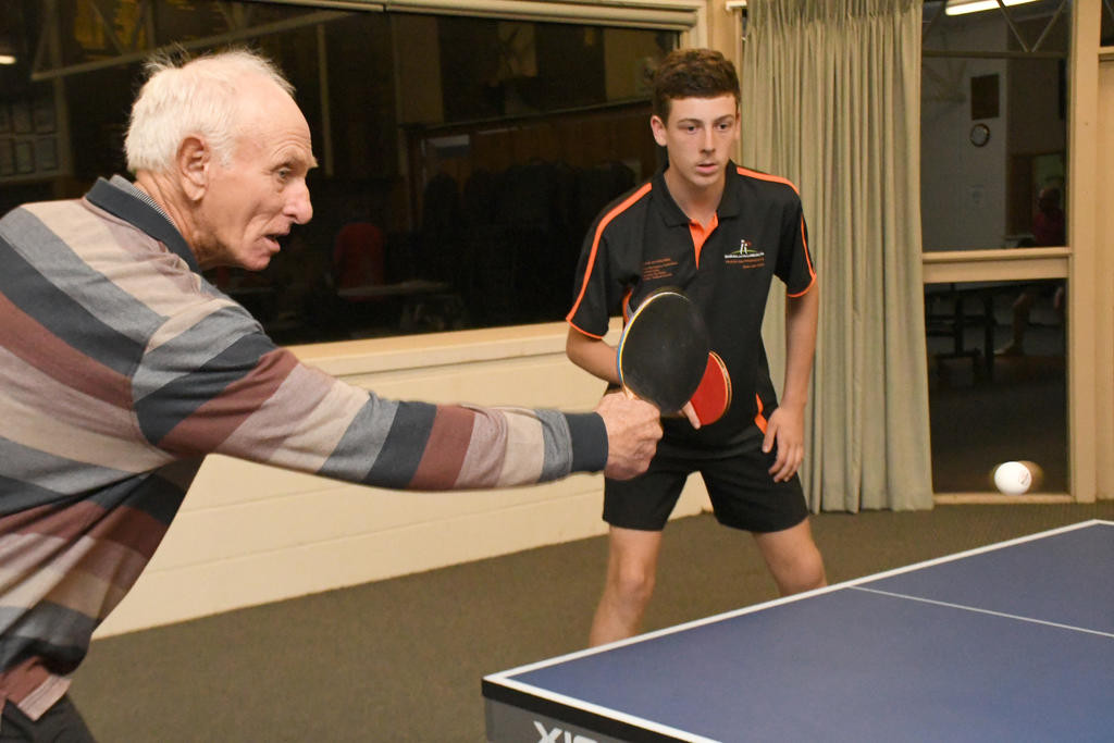 Graeme Koschitzke makes a backhand return as playing partner Will Martin watches on.