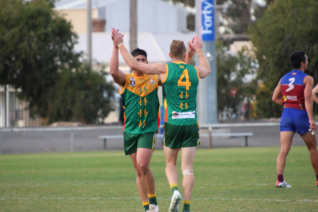 Andrew Moore and Jack Williams celebrate a goal in their clash with the Demons.