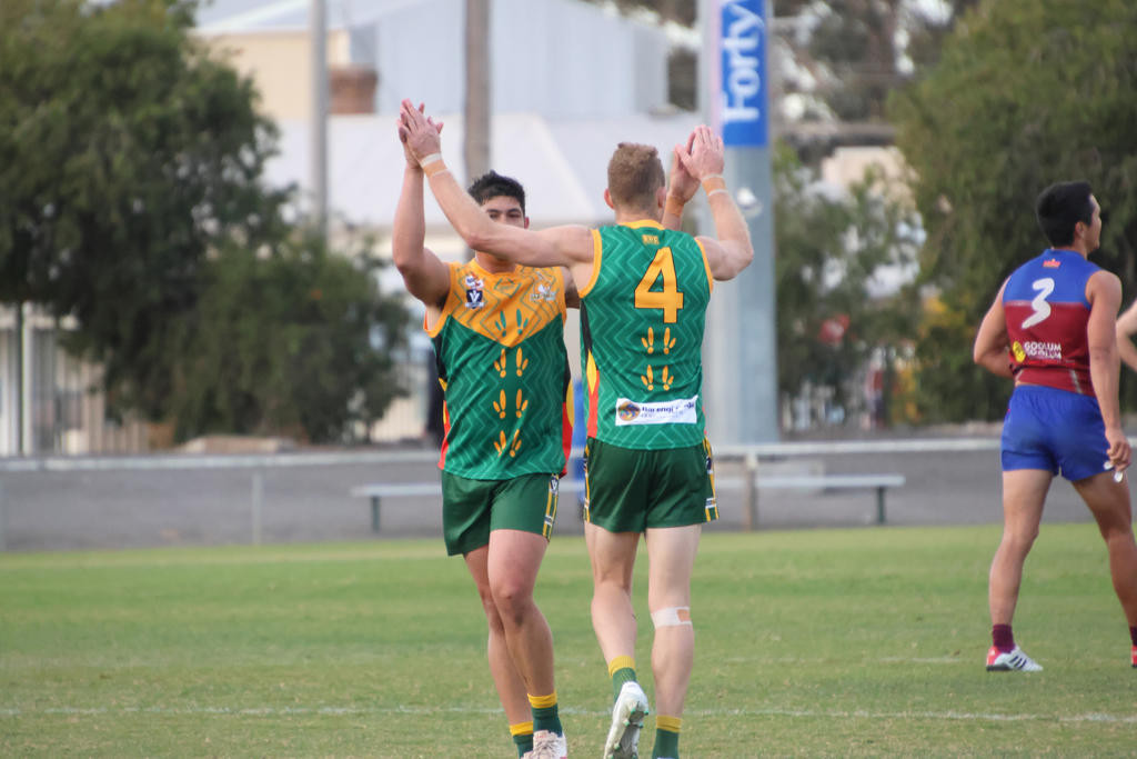 Andrew Moore and Jack Williams celebrate a goal in their clash with the Demons.