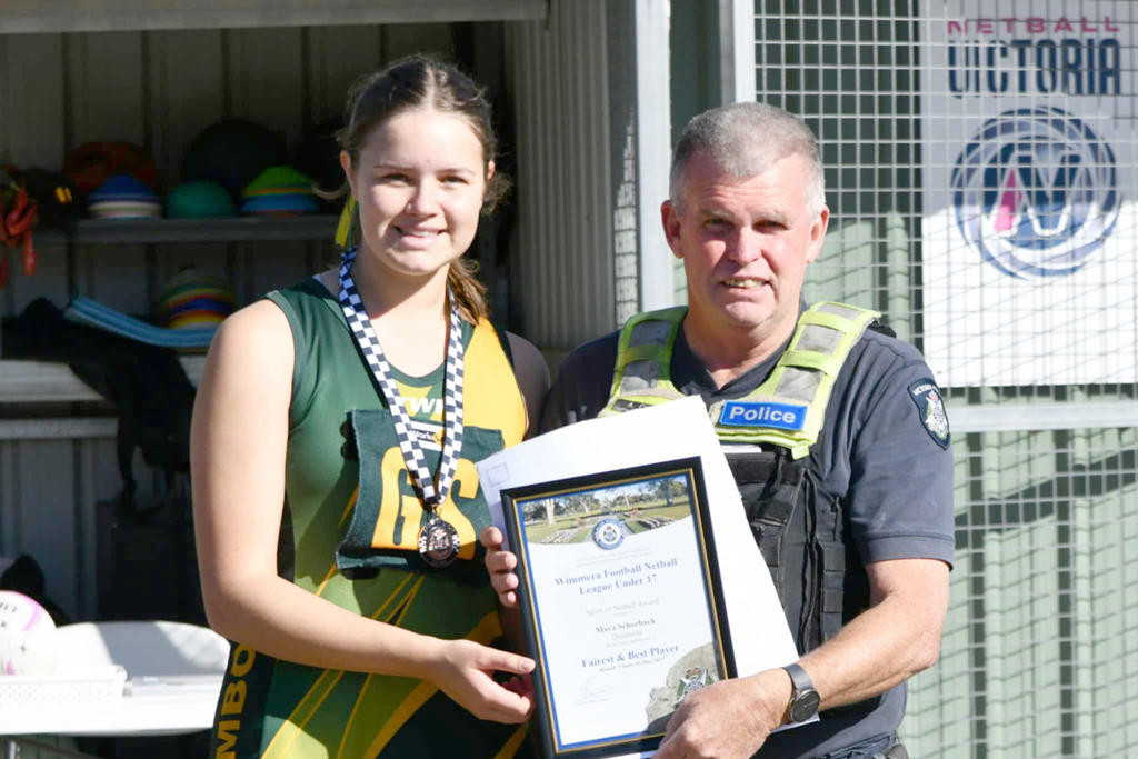 Maya Schorback receives her award from Leading Senior Constable Anthony Clark.
