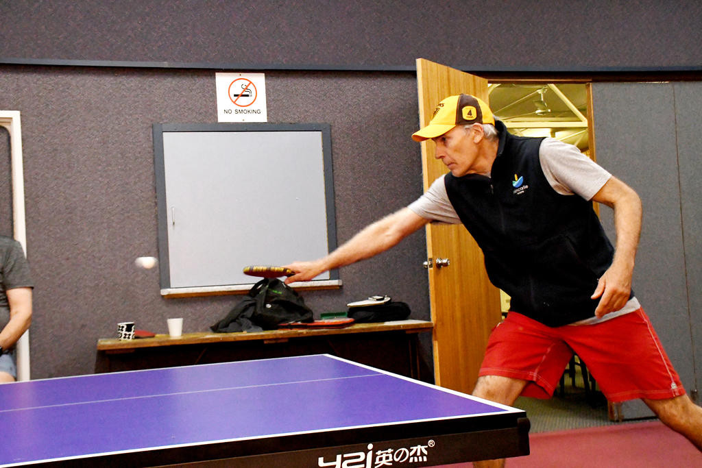 Wallup's Brad Martin makes a backhand return during his match on Monday night.