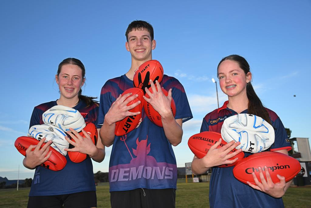 Laharum Football Netball Club's Sienna Wood, 15, Bailey Barry, 16, and Marnie Roberts, 14, with the bounty of gear purchased with the Active Kids Grant.