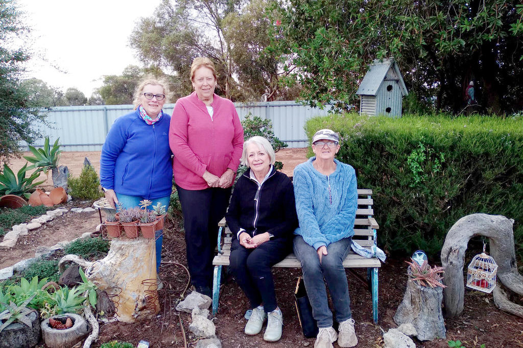 Lynne McKenzie, Joy Mathews, Helen Fisher and Debbie Lowe enjoy a break in the Rainbow Golf Club garden. Fay Martion is the main carer for this garden and has many quirky homemade items on display.