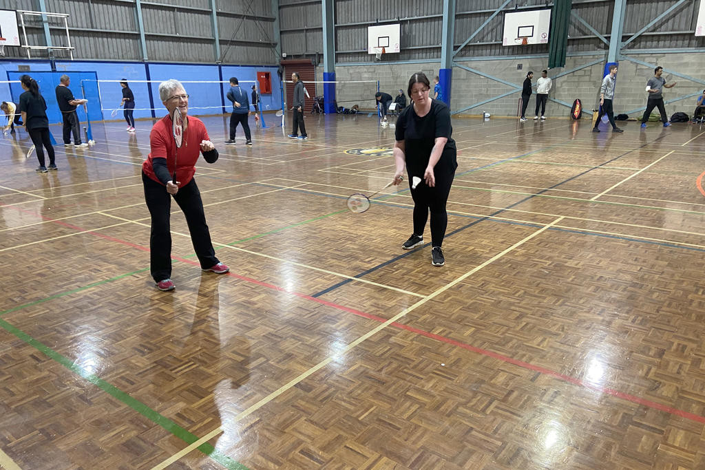 Amy Barton, alongside Helen Francisco, serving during their A Grade clash against the Shuttle Shifters.