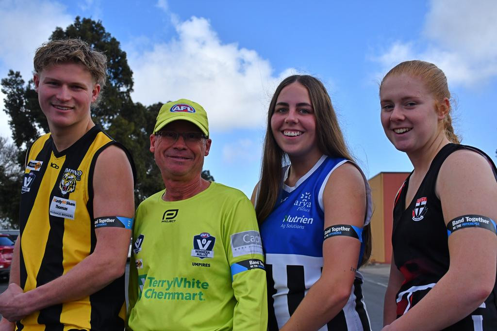 Pimpinio footballer Tom Baker, umpire Dave Thomas, Minyip Murtoa footballer Jayde Ellis, and Horsham Saints' netballer Ash Ison don the blue armband for the statewide TAC road safety round.