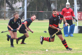 Johathon Horsfall of the Horsham Hurricanes looks for options before clearing the ball out of defence.