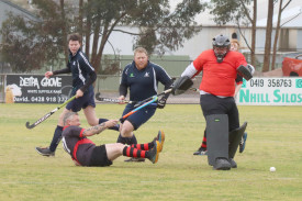 Tigers’ goalkeeper Al Dickinson blocks a desperate scoring attempt by Horsham Hurricanes’ Brett Luy, with Tigers’ teammates Archie Zanker and Jamie Harding in support.