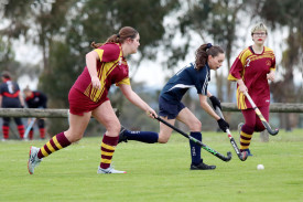 Yanac’s Mikayla Farmers runs the ball ahead of Warrack’s Madisson Bentley and Eddie Bull.