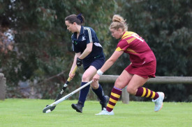 Yanac’s Alexis Farmers runs with the ball under pressure from Warrack’s Ellie Williamson.