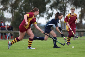 Yanac’s Mikayla Farmers runs the ball ahead of Warrack’s Madisson Bentley and Eddie Bull.