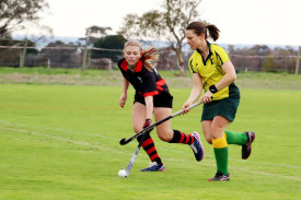 Dimboola Roos’ Brooke McMaster runs with the ball while Horsham Jets’ Annabelle Heal attempts to block her progress.