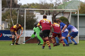 Cameron Bardell traps the ball and prepares for a shot a goal as Cobras’ goalkeeper Thomas Ady braces to defend in a crowded Warrack Hoops’ forward line.