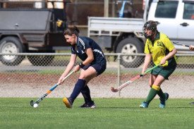 Yanac’s Erin Alexander takes control of the ball during a penalty corner as opponent Jennie Hauselberger swoops in to tackle.