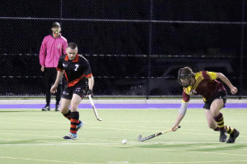 Warrack Hoops’ defender Hamish Wagenknecht (right) shapes to sweep the ball away before Jason Harris can gain control, all under the watchful eye of umpire Brad Alexander.
