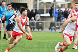 Ararat’s Brody Griffin assesses his options with the ball in hand during Saturday’s grand final.
