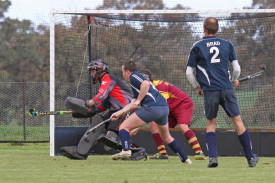 Hoops’ goalkeeper Russell Brown braces to block a shot during a Tigers’ penalty corner.