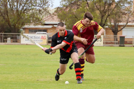 Hurricanes’ Jason Harris gets off a shot before Hoops’ Oskar Bennet can tackle.