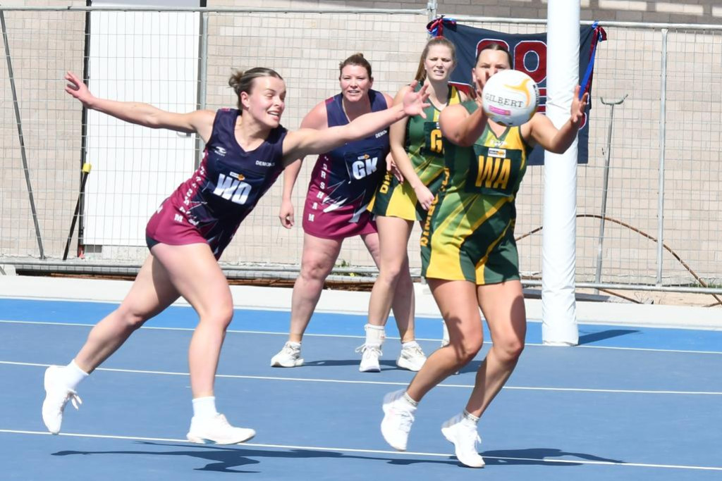 Horsham's Keely Pope reaches for a pass intended for Dimboola's Billie Barber.