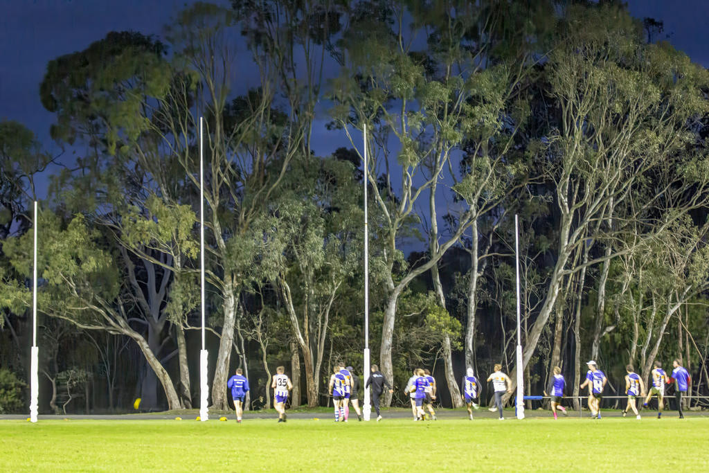 Training under lights on Tuesday evening, the senior footy players from Harrow-Balmoral are hoping for their third premiership in a row this Saturday, with Kangaroos signage (inset) of a different type on roads around the towns supporting the team.