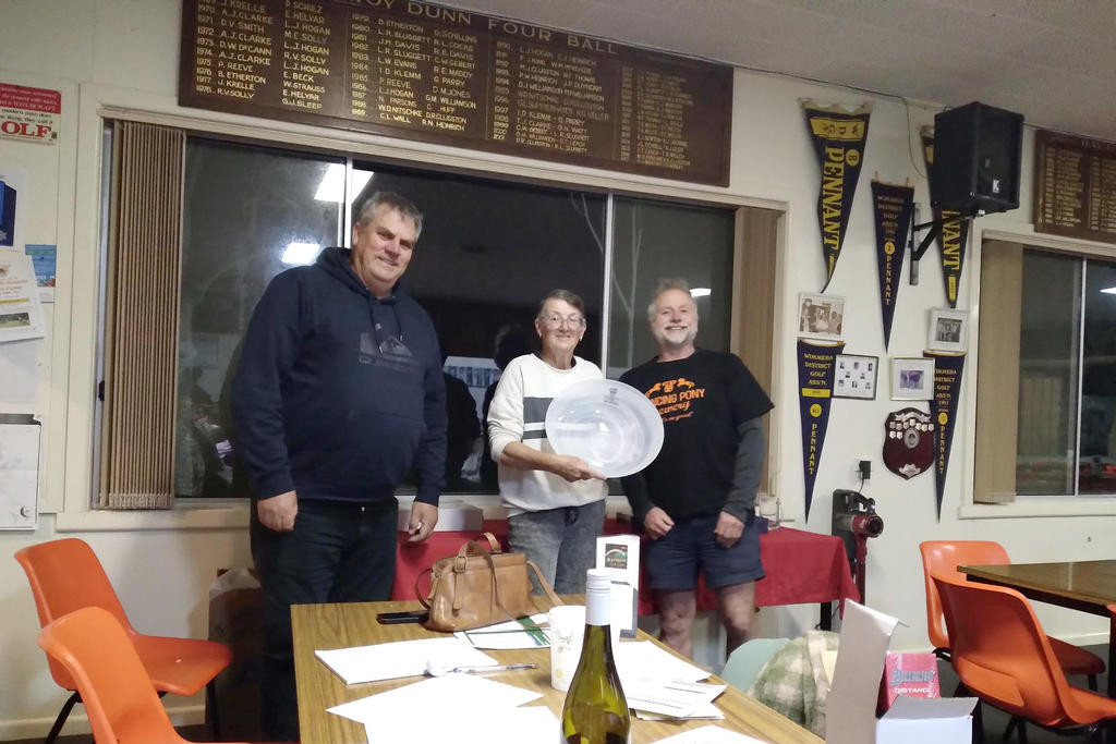 Ladies' club champion Debbie Lowe receives her trophy from vice-president Travis Clarke and captain Steve Leach.