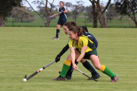 Dimboola’s Brooke McMaster sweeps the ball under pressure from Yanac’s Mikayla Mackley.