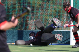 Horsham Hurricanes’ goalkeeper Lars Simmons throws himself into blocking a Tigers shot at goal during a penalty corner.