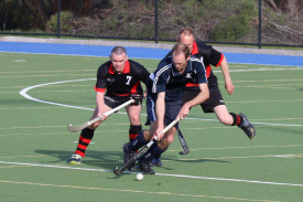 Yanac Tigers’ Bradley Alexander manoeuvres the ball away from opponents Jason Harris and Jeff Mills.
