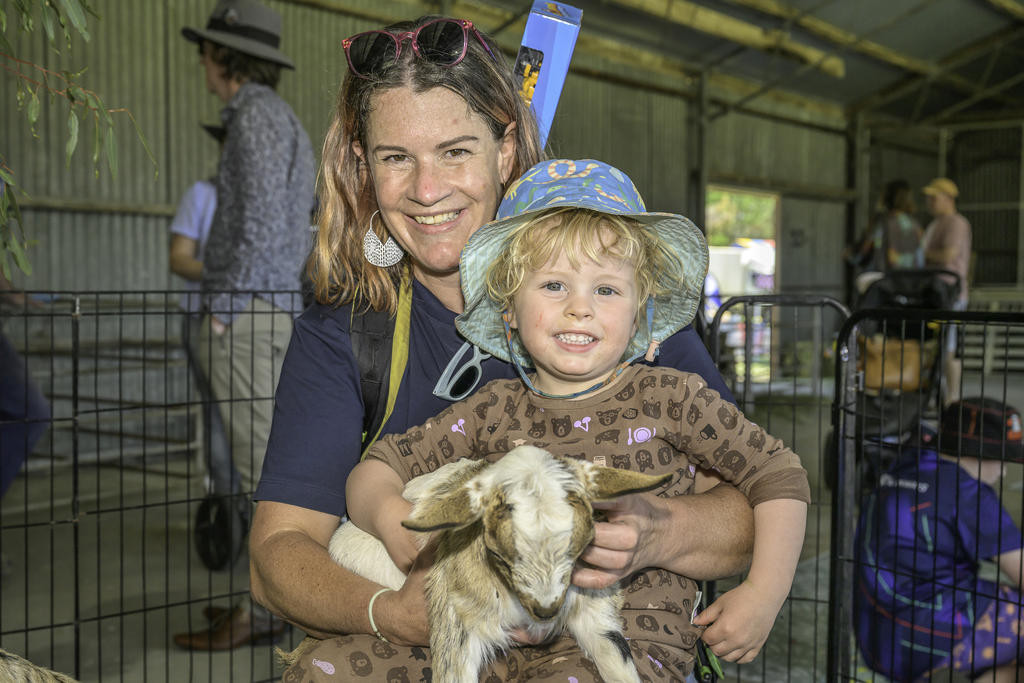Catherine Devaus holding Seb Demmert holding a tiny goat.