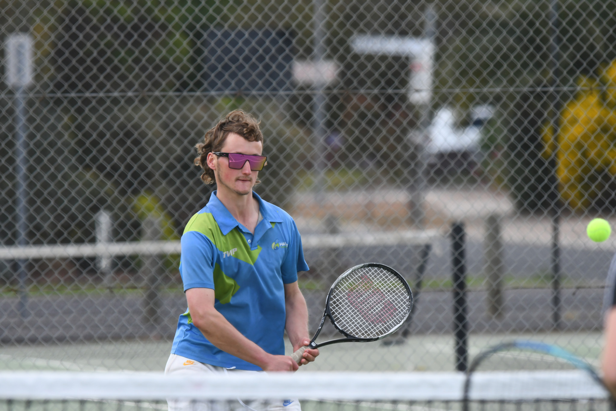 Haven’s Thomas Mott prepares a backhand volley in a B special doubles rubber against Central Park.
