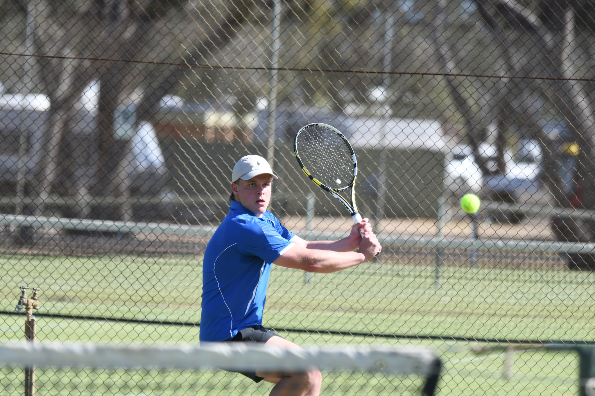 Brimpaen’s Ben Dunn keeps his eye on the ball during one of his team’s A special doubles rubbers against Horsham Lawn.
