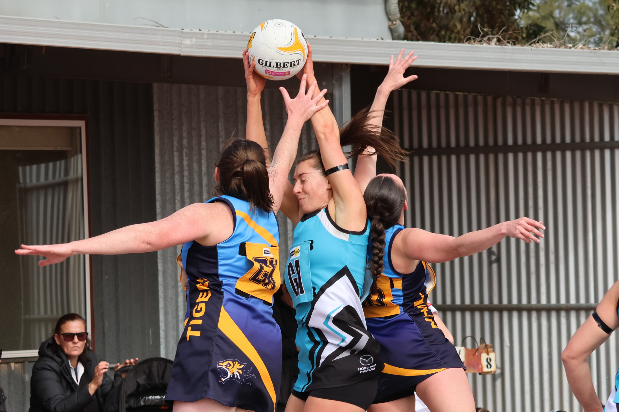 SMT's Steph Thompson is sandwiched by the two Nhill defenders. Photo: LES GRAETZ