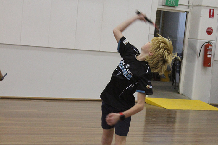 Xavier Hollamby unleashes his serve.