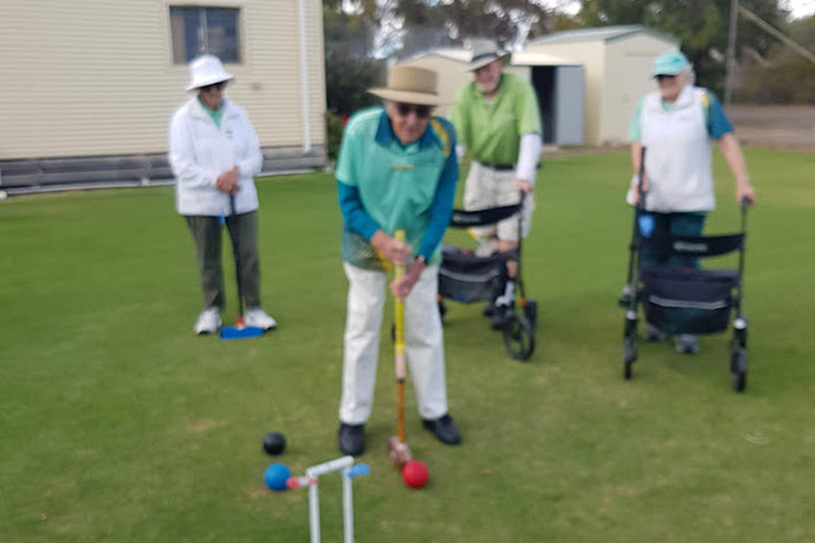 Kneller Lehmann lines up the red ball for a long shot towards the last hoop watched by Judy Baker, Charles Rees and Jan Post.