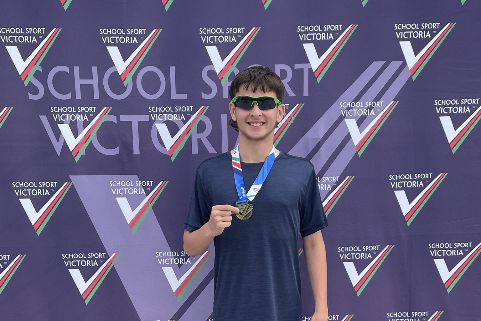 Jett Hill with his gold medal after winning the School Sport Victoria under 13s 400m at the state track and field championships.